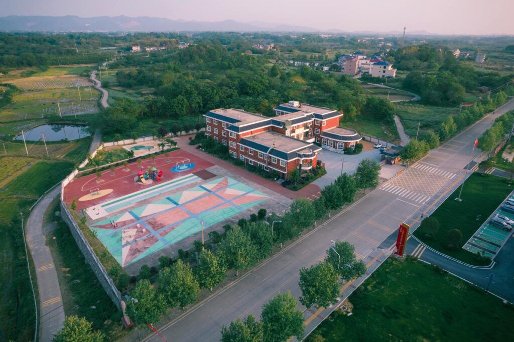 drone shot of school building with playground